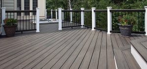 Dark brown wooden deck with white railing