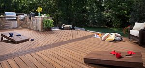 Wooden deck with a grill and cornhole boards